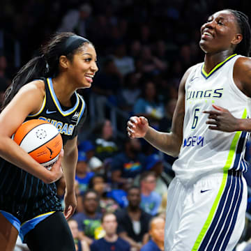 May 15, 2024; Arlington, Texas, USA;  Chicago Sky forward Angel Reese (5) laughs with Dallas Wings forward Natasha Howard (6) during the second half at College Park Center. Mandatory Credit: Kevin Jairaj-Imagn Images