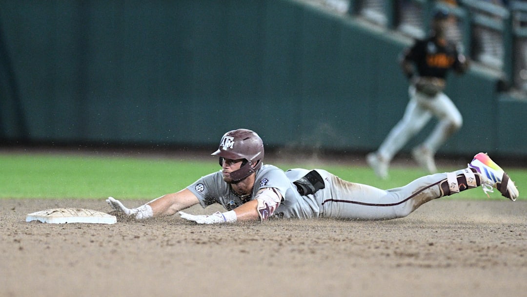 Jun 24, 2024; Omaha, NE, USA;  Texas A&M Aggies third baseman Gavin Grahovac (9) slides into second base with a double to lead off against the Tennessee Volunteers during the ninth inning at Charles Schwab Field Omaha. Mandatory Credit: Steven Branscombe-Imagn Images