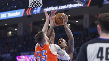 Feb 1, 2025; Oklahoma City, Oklahoma, USA; Sacramento Kings forward DeMar DeRozan (10) is defended by Oklahoma City Thunder center Isaiah Hartenstein (55) during the second quarter at Paycom Center. Mandatory Credit: Alonzo Adams-Imagn Images