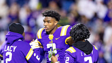 Nov 30, 2024; Baton Rouge, Louisiana, USA;  LSU Tigers wide receiver Kyren Lacy (2) hugs his family as seniors are being honored during the beginning of the first quarter at Tiger Stadium. Mandatory Credit: Stephen Lew-Imagn Images