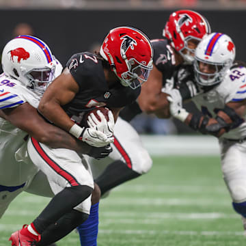 Atlanta Falcons running back Bijan Robinson (7) is tackled by Buffalo Bills defensive tackle Deone Walker (96) during the second half of a game at Mercedes-Benz Stadium.