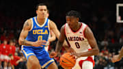 Dec 14, 2024; Phoenix, Arizona, USA; Arizona Wildcats guard Jaden Bradley (right) against UCLA Bruins guard Kobe Johnson at Footprint Center. Mandatory Credit: Mark J. Rebilas-Imagn Images
