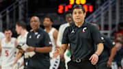 Cincinnati Bearcats head coach Wes Miller pulls in his team for a huddle in the first half of the NCAA basketball game between the Cincinnati Bearcats and the West Virginia Mountaineers at Fifth Third Arena in Cincinnati on Sunday, Feb. 2, 2025.