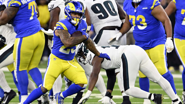 Nov 24, 2024; Inglewood, California, USA;  Los Angeles Rams running back Kyren Williams (23) runs past Philadelphia Eagles linebacker Nakobe Dean (17) during the first half at SoFi Stadium. Mandatory Credit: Alex Gallardo-Imagn Images