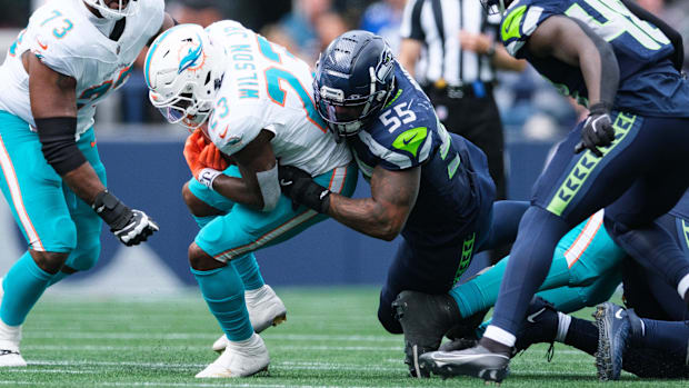Seattle Seahawks defensive end Dre'Mont Jones (55) tackles Miami Dolphins running back Jeff Wilson Jr. (23).