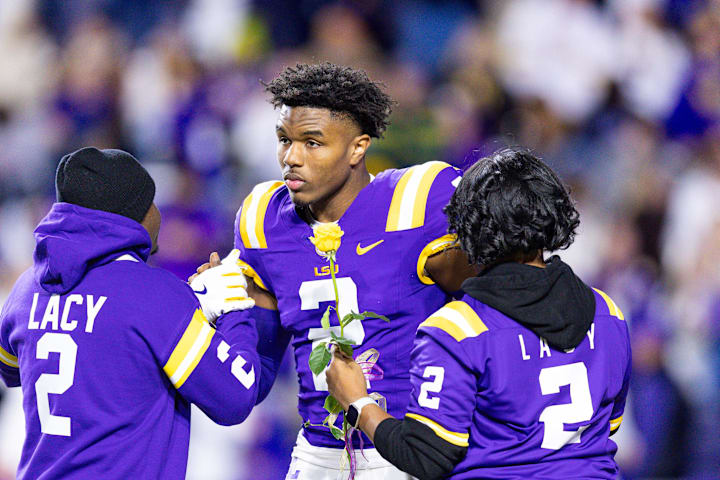 LSU Tigers wide receiver Kyren Lacy hugs his family as seniors are being honored before a game at Tiger Stadium. 