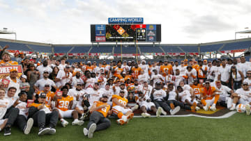 Jan 1, 2024; Orlando, FL, USA; Tennessee Volunteers players pose for a photo to celebrate the win over the Iowa Hawkeyes at Camping World Stadium. Mandatory Credit: Morgan Tencza-USA TODAY Sports