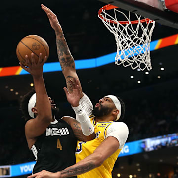 Apr 12, 2024; Memphis, Tennessee, USA; Los Angeles Lakers forward Anthony Davis (3) defends as Memphis Grizzlies guard Jordan Goodwin (4) drives to the basket during the second half at FedExForum. Mandatory Credit: Petre Thomas-Imagn Images