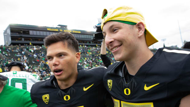 Oregon quarterbacks Dillon Gabriel, left, and Ryder Hayes leave the field after the Oregon Spring Game 