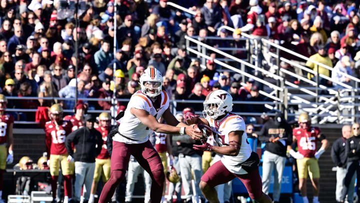 Nov 11, 2023; Chestnut Hill, Massachusetts, USA; Virginia Tech Hokies quarterback Kyron Drones (1) and cornerback Miles Ellis (33) during the first half against the Boston College Eagles at Alumni Stadium. Mandatory Credit: Eric Canha-USA TODAY Sports