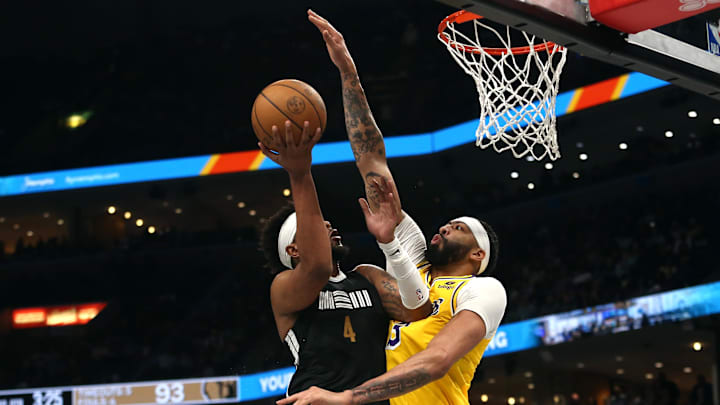 Apr 12, 2024; Memphis, Tennessee, USA; Los Angeles Lakers forward Anthony Davis (3) defends as Memphis Grizzlies guard Jordan Goodwin (4) drives to the basket during the second half at FedExForum. Mandatory Credit: Petre Thomas-Imagn Images