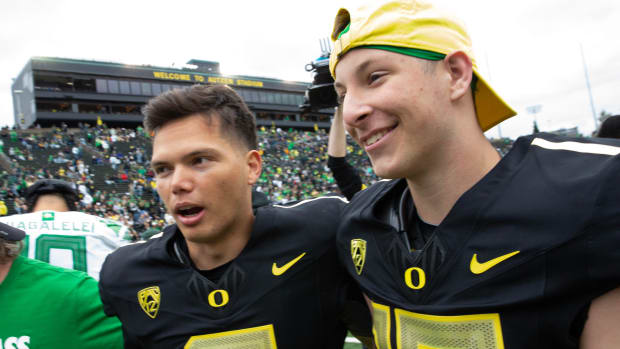 Oregon quarterbacks Dillon Gabriel, left, and Ryder Hayes leave the field after the Oregon Spring Game 