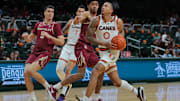 Jan 8, 2025; Coral Gables, Florida, USA; Miami Hurricanes guard Matthew Cleveland (0) drives to the basket against the Florida State Seminoles during the second half at Watsco Center. Mandatory Credit: Sam Navarro-Imagn Images
