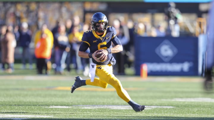 Nov 18, 2023; Morgantown, West Virginia, USA; West Virginia Mountaineers quarterback Garrett Greene (6) runs for extra yards during the first quarter against the Cincinnati Bearcats at Mountaineer Field at Milan Puskar Stadium. Mandatory Credit: Ben Queen-USA TODAY Sports