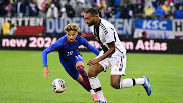 Oct 14, 2023; East Hartford, Connecticut, USA; United States defender Kevin Paredes (16) and Germany defender Jonathan Tah (4) battle for control of the ball during the second half at Pratt & Whitney Stadium. Mandatory Credit: Eric Canha-Imagn Images