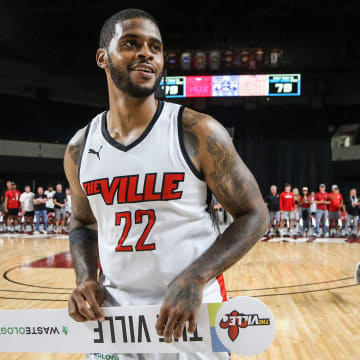 TheVille's Chane Behanan smiles while carrying the team's placard after the team defeated Jackson TN at the TBT second round of the Louisville Regional at Freedom Hall July 27, 2023.