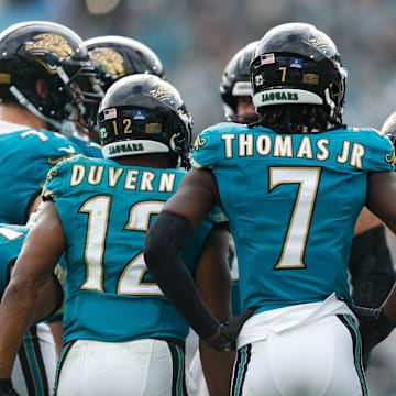 Dec 15, 2024; Jacksonville, Florida, USA; Jacksonville Jaguars wide receiver Brian Thomas Jr. (7), wide receiver Devin Duvernay (12), wide receiver Parker Washington (11), running back Travis Etienne Jr. (1) and the offense huddle against the New York Jets during the second quarter at EverBank Stadium. Mandatory Credit: Morgan Tencza-Imagn Images