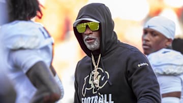 Nov 23, 2024; Kansas City, Missouri, USA;  Colorado head coach Deion Sanders watches his players warmup prior to the game between the Kansas Jayhawks and the Colorado Buffaloes at GEHA Field at Arrowhead Stadium. Mandatory Credit: Nick Tre. Smith-Imagn Images
