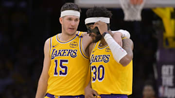 Feb 10, 2025; Los Angeles, California, USA; Los Angeles Lakers guard Austin Reaves (15) talks with guard Jordan Goodwin (30) in the second half against the Utah Jazz at Crypto.com Arena. Mandatory Credit: Jayne Kamin-Oncea-Imagn Images