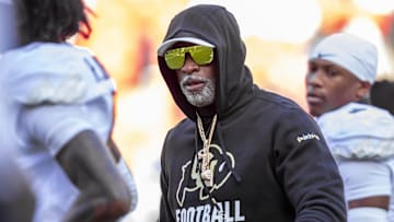 Nov 23, 2024; Kansas City, Missouri, USA;  Colorado head coach Deion Sanders watches his players warmup prior to the game between the Kansas Jayhawks and the Colorado Buffaloes at GEHA Field at Arrowhead Stadium. Mandatory Credit: Nick Tre. Smith-Imagn Images
