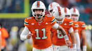Aug 31, 2025; Miami Gardens, Florida, USA; Miami Hurricanes quarterback Carson Beck (11) practices before the game against the Notre Dame Fighting Irish at Hard Rock Stadium. Mandatory Credit: Sam Navarro-Imagn Images