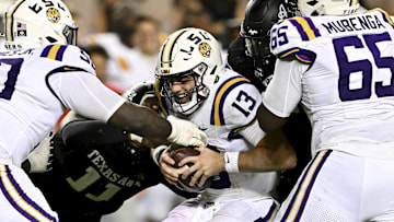 Oct 26, 2024; College Station, Texas, USA; LSU Tigers quarterback Garrett Nussmeier (13) is sacked by Texas A&M Aggies defensive lineman Nic Scourton (11) in the fourth quarter at Kyle Field. Mandatory Credit: Maria Lysaker-Imagn Images. 