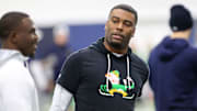 Notre Dame cornerbacks coach Mike Mickens speaks to former Irish cornerback TaRiq Bracy Saturday, March 25, 2023, at Notre Dame spring football practice in South Bend