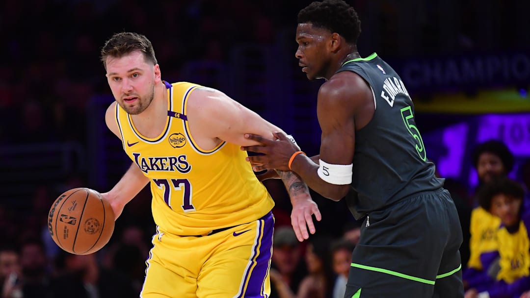Apr 30, 2025; Los Angeles, California, USA; Los Angeles Lakers guard Luka Doncic (77) controls the ball against Minnesota Timberwolves guard Anthony Edwards (5) during the first half in game five of first round for the 2025 NBA Playoffs at Crypto.com Arena. Mandatory Credit: Gary A. Vasquez-Imagn Images