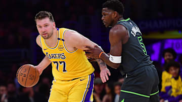 Apr 30, 2025; Los Angeles, California, USA; Los Angeles Lakers guard Luka Doncic (77) controls the ball against Minnesota Timberwolves guard Anthony Edwards (5) during the first half in game five of first round for the 2025 NBA Playoffs at Crypto.com Arena. Mandatory Credit: Gary A. Vasquez-Imagn Images