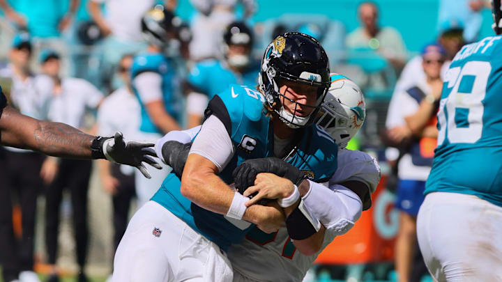 Sep 8, 2024; Miami Gardens, Florida, USA; Jacksonville Jaguars quarterback Trevor Lawrence (16) is sacked by Miami Dolphins defensive tackle Da'Shawn Hand (91) during the fourth quarter at Hard Rock Stadium. Mandatory Credit: Sam Navarro-Imagn Images