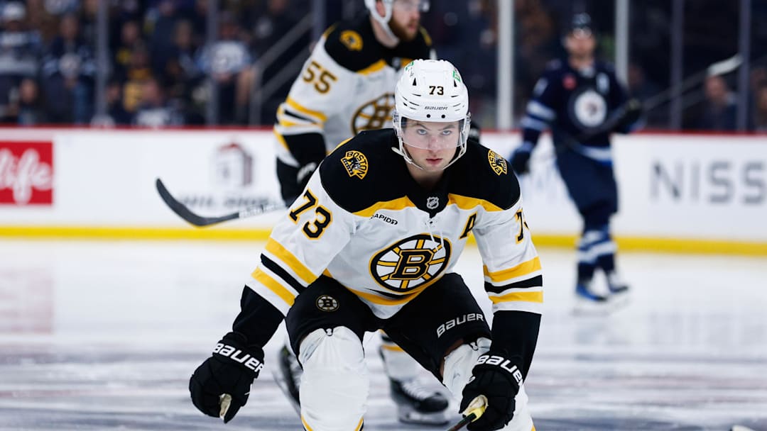 Dec 10, 2024; Winnipeg, Manitoba, CAN;  Boston Bruins defenseman Charlie McAvoy (73) skates after the puck against the Winnipeg Jets during the second period at Canada Life Centre. Mandatory Credit: Terrence Lee-Imagn Images