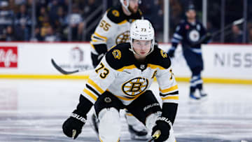 Dec 10, 2024; Winnipeg, Manitoba, CAN;  Boston Bruins defenseman Charlie McAvoy (73) skates after the puck against the Winnipeg Jets during the second period at Canada Life Centre. Mandatory Credit: Terrence Lee-Imagn Images