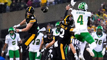 Iowa Hawkeyes defensive back Zach Lutmer (6) and Iowa Hawkeyes defensive back TJ Hall (2) defend a pass meant for Oregon Ducks wide receiver Malik Benson (4) Nov. 8, 2025 during a Big Ten Football game at Kinnick Stadium in Iowa City, Iowa.