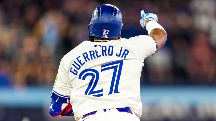 Jun 29, 2024; Toronto, Ontario, CAN; Toronto Blue Jays first base Vladimir Guerrero Jr. (27) hits a home run against the New York Yankees at Rogers Centre.