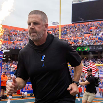 Florida Gators head coach Billy Napier runs onto the field before the start of the game at Ben Hill Griffin Stadium in Gainesville, FL on Saturday, September 7, 2024 against the Samford Bulldogs. The Gators won 45-7. 