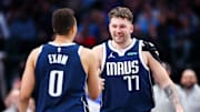 Dec 23, 2023; Dallas, Texas, USA;  Dallas Mavericks guard Luka Doncic (77) celebrates with Dallas Mavericks guard Dante Exum (0) during the second half against the San Antonio Spurs at American Airlines Center. Mandatory Credit: Kevin Jairaj-Imagn Images
