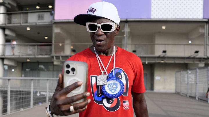 Jul 30, 2024; Paris Saint-Denis, France; Flavor Flav on his phone outside of the stadium before the bronze medal women's Rugby Sevens match during the Paris 2024 Olympic Summer Games at Stade de France.