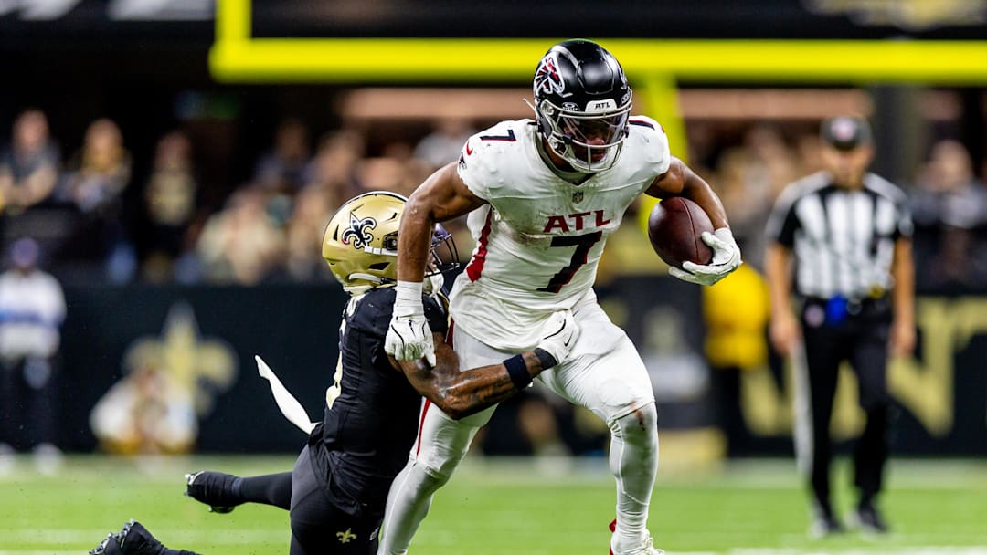 Nov 10, 2024; New Orleans, Louisiana, USA;   Atlanta Falcons running back Bijan Robinson (7) makes a first down against New Orleans Saints cornerback Will Harris (5) during the second half at Caesars Superdome. Mandatory Credit: Stephen Lew-Imagn Images