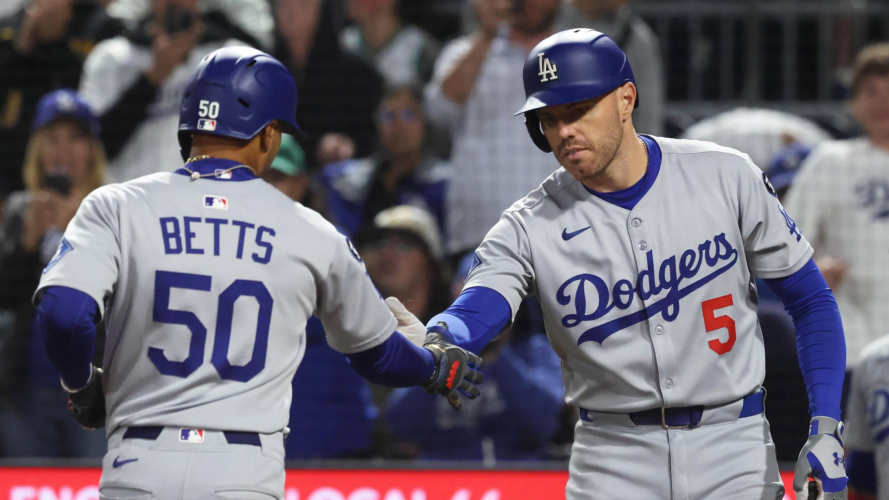 Sep 4, 2025; Pittsburgh, Pennsylvania, USA; Los Angeles Dodgers first baseman Freddie Freeman (5) congratulates shortstop Mookie Betts (50) crossing home plate on a solo home run against the Pittsburgh Pirates during the ninth inning at PNC Park. Mandatory Credit: Charles LeClaire-Imagn Images