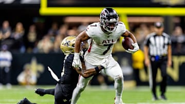 Nov 10, 2024; New Orleans, Louisiana, USA;   Atlanta Falcons running back Bijan Robinson (7) makes a first down against New Orleans Saints cornerback Will Harris (5) during the second half at Caesars Superdome. Mandatory Credit: Stephen Lew-Imagn Images