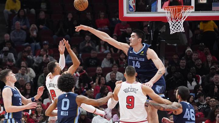 Oct 12, 2024; Chicago, Illinois, USA; Memphis Grizzlies center Zach Edey (14) defends Chicago Bulls guard Zach LaVine (8) during the first half at United Center. Mandatory Credit: David Banks-Imagn Images