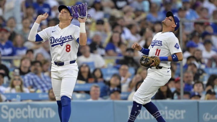 Jun 21, 2024; Los Angeles, California, USA;  Los Angeles Dodgers third baseman Enrique Hernandez (8) backs off allowing shortstop Miguel Rojas (11) to catch a pop up in the third inning against the Los Angeles Angels at Dodger Stadium. Mandatory Credit: Jayne Kamin-Oncea-USA TODAY Sports