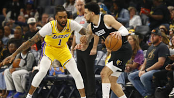 Apr 12, 2024; Memphis, Tennessee, USA; Memphis Grizzlies guard Scotty Pippen Jr. (1) dribbles as Los Angeles Lakers guard D'Angelo Russell (1) defends during the first half at FedExForum. Mandatory Credit: Petre Thomas-Imagn Images