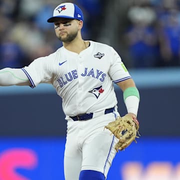 Nov 1, 2025; Toronto, Ontario, CAN; Toronto Blue Jays designated hitter Bo Bichette (11) throws to first for an out against Los Angeles Dodgers second baseman Tommy Edman (25) in the eighth inning during game seven of the 2025 MLB World Series at Rogers Centre. Mandatory Credit: John E. Sokolowski-Imagn Images