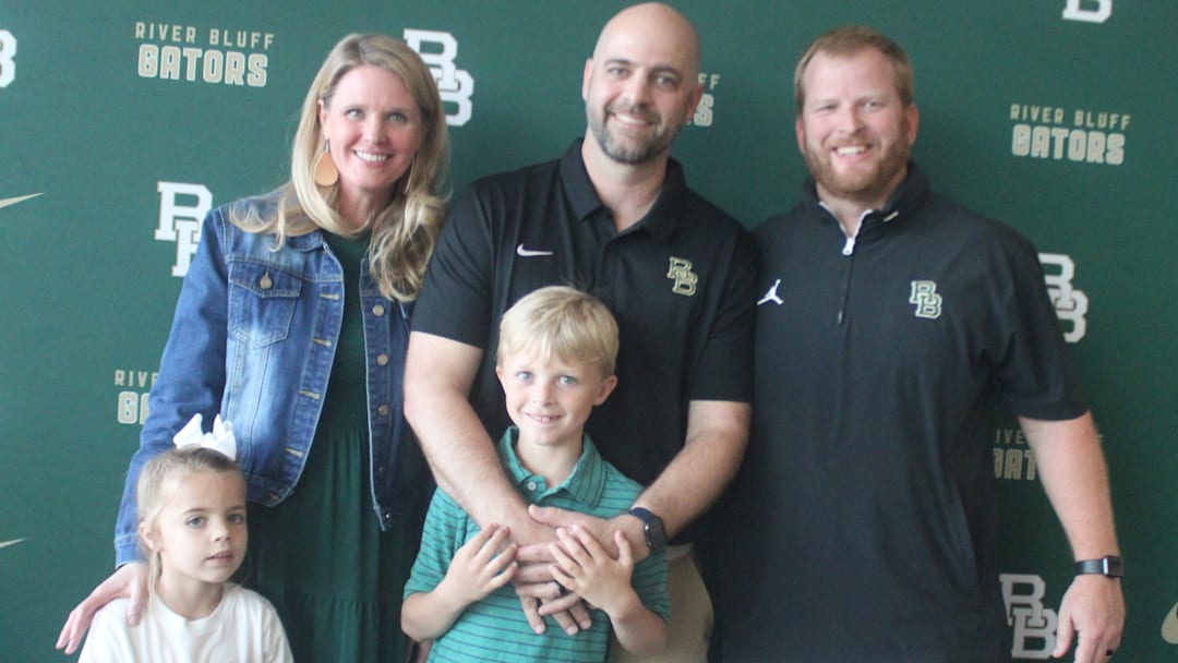 New River Bluff head coach Will Clarke with his family and Athletics Director Andrew Peckham. 