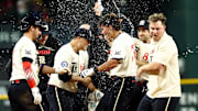 Texas Rangers right fielder Dustin Harris (38) celebrates with teammates after hitting the game-winning double against the Houston Astros during the twelfth inning  at Globe Life Field. 