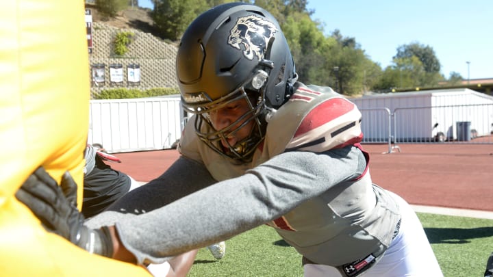 Defensive end Sterling Lane hits the bags