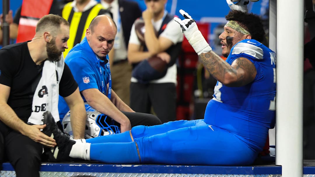 Nov 2, 2025; Detroit, Michigan, USA; Detroit Lions offensive lineman Christian Mahogany (73) is helped off the field after an injury in the fourth quarter against the Minnesota Vikings at Ford Field. Mandatory Credit: David Reginek-Imagn Images