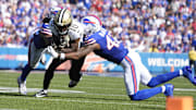 Sep 28, 2025; Orchard Park, New York, USA;  New Orleans Saints wide receiver Brandin Cooks (10) is tackled by Buffalo Bills cornerback Christian Benford (47) and linebacker Dorian Williams (42) during the fourth quarter at Highmark Stadium. Mandatory Credit: Gregory Fisher-Imagn Images