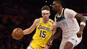  Los Angeles Lakers guard Austin Reaves (15) drives against Minnesota Timberwolves center Naz Reid (11) during the second quarter at Crypto.com Arena.